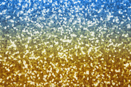 Glitter background blue, yellow, glitter background, shiny surfactant. Holiday abstract glitter background with flashing lightの写真素材