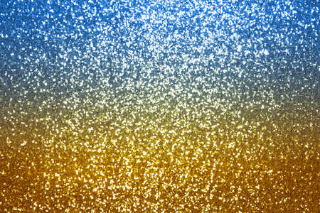 Glitter background blue, yellow, glitter background, shiny surfactant. Holiday abstract glitter background with flashing lightの写真素材