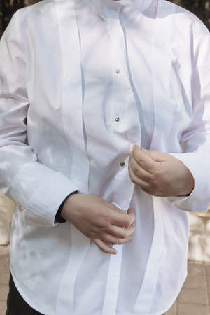 white women's blouse with placket, close-up shot on metal buttons, casual styleの写真素材