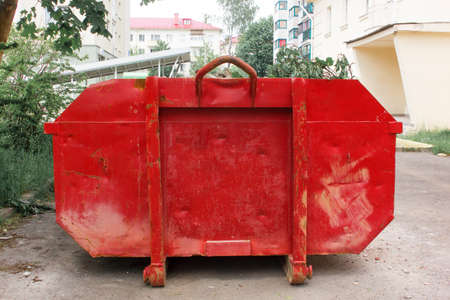 Red container with solid domestic and construction waste.の写真素材