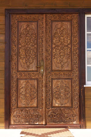 Persian Islamic design consisting of flowers carved on the surface of an old wooden door.の写真素材