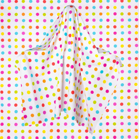 Funny ghost with colorful polka dots on an edentulous background. Mystical sign, icon, avatar.の写真素材