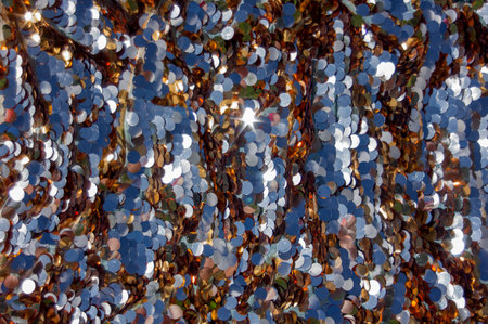 Shiny gold background with iridescent sparkles, sequins. Festive background.の写真素材