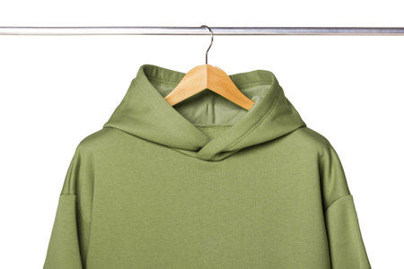 Sweatpants from a green sweatshirt hang on a wooden hanger. The concept of modern comfortable sportswear.の写真素材