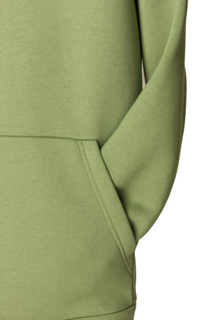 Sweatpants from a green sweatshirt hang on a wooden hanger. The concept of modern comfortable sportswear.の写真素材