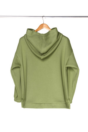 Sweatpants from a green sweatshirt hang on a wooden hanger. The concept of modern comfortable sportswear.の写真素材
