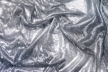 Fabric decorated with silver sequins, draped, holiday concept. Sparkle glitter backgroundの写真素材
