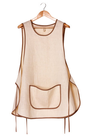 Kitchen linen eco-friendly women's apron on a wooden hanger. front view. isolated on white background.の写真素材