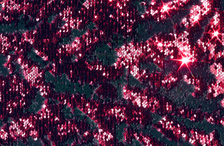 Pink, red background with sparkles, shiny golden fabric with sequins.の写真素材