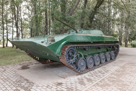 Military modern Russian green tank on tracks with a cannon, close-up view.