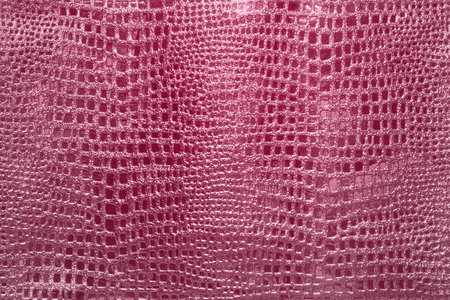 pink background of the skin of a snake, alligator, python, fashion, luxuryの写真素材