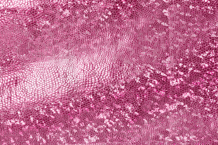 pink background of the skin of a snake, alligator, python, fashion, luxuryの写真素材