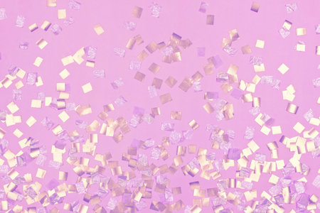 gold square sequins on pink backgroundの写真素材