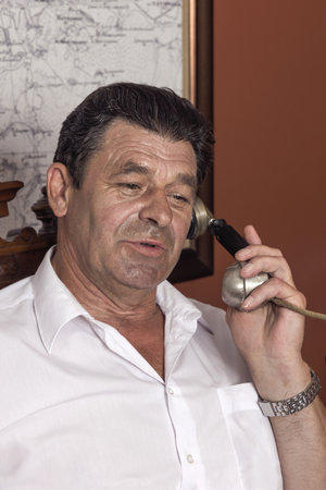 Vintage manager, forties, man talking on a corded phoneage director, forties, man talking on a corded phoneの写真素材