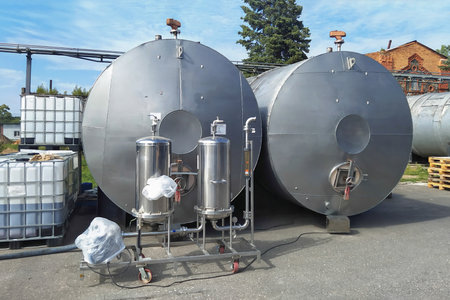 Stainless steel ethanol storage tanks. Ground storage. Industrial factory territory.の写真素材