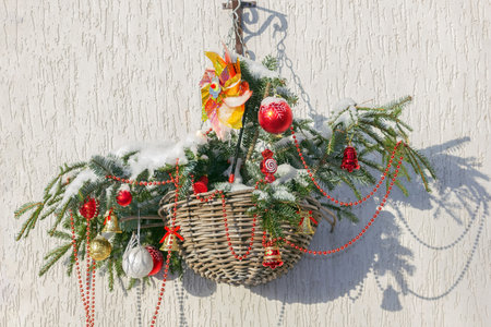 Christmas decor outside the house, balls and fir branches in baskets. New Year card. Background.の写真素材