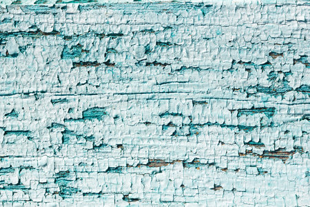 Cracked blue paint on a wooden board, craquelure, unique natural, natural, vintage background.の写真素材