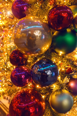 Christmas red and gold balls all with lights and bulbs lights on the Christmas tree, Christmas card.の写真素材