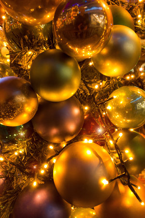 Christmas red and gold balls all with lights and bulbs lights on the Christmas tree, Christmas card.の写真素材