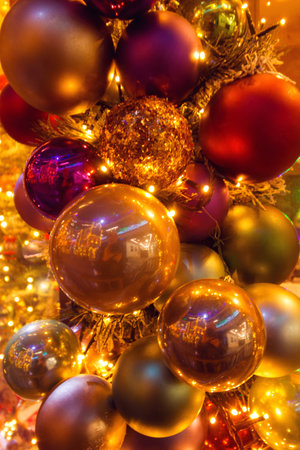 Christmas red and gold balls all with lights and bulbs lights on the Christmas tree, Christmas card.の写真素材
