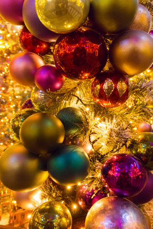 Christmas red and gold balls all with lights and bulbs lights on the Christmas tree, Christmas card.の写真素材