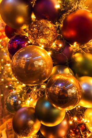 Christmas red and gold balls all with lights and bulbs lights on the Christmas tree, Christmas card.の写真素材