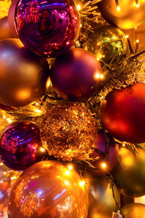 Christmas red and gold balls all with lights and bulbs lights on the Christmas tree, Christmas card.の写真素材