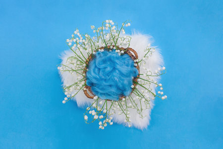 Cosmetics on blue background and premium podium with lily of the valley flowers for branding and product presentation packaging, use it as wallpaper, posters and banners.の写真素材
