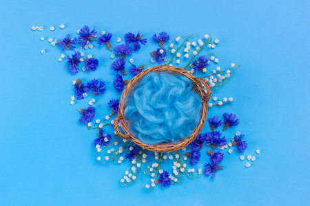 Cosmetics on blue background and premium podium with lily of the valley flowers for branding and product presentation packaging, use it as wallpaper, posters and banners.の写真素材