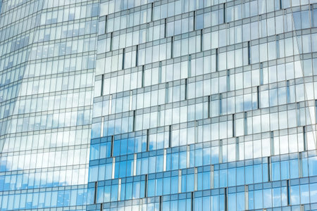Clouds reflected in the windows of a modern office building.の写真素材