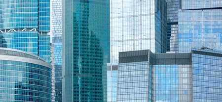 Modern skyscraper building, uniform background covered with glass windows with numerous reflections.の写真素材