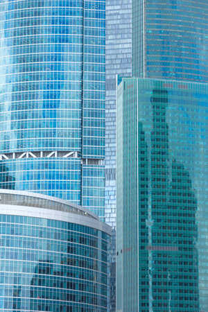 Modern skyscraper building, uniform background covered with glass windows with numerous reflections.の写真素材