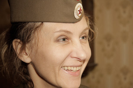 Close-up portrait of a woman in a military cap. Close-up, retro portrait.の写真素材