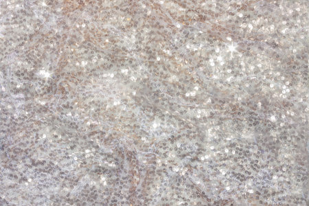 Background made of white shiny fabric with sequins. For your design for Christmas or wedding.の写真素材