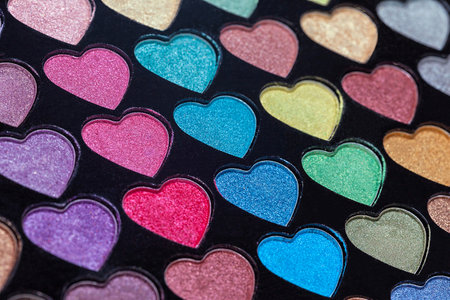 Heart Shaped Eyeshadow Set. Eyeshadow palette with colorful heart shaped refills close-up. Macro eyeshadow.の写真素材