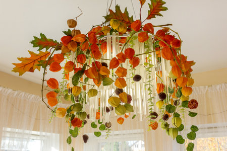 Room interior, chandelier decorated for Halloween. Interior with chandelier entwined with physalis, decorated for Halloween.の写真素材