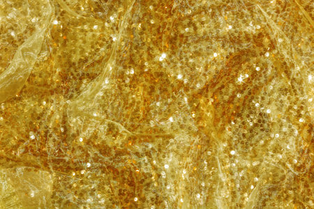 Sparkly golden festive background with sequins. Space for text.の写真素材