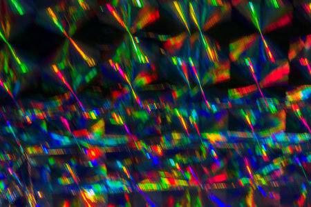Abstract blurred background of colorful holographic foil lens flare. Holiday background.の写真素材