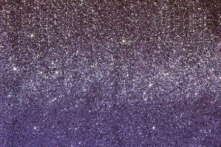 Beautiful elegant shiny purple gold luxurious fabric texture with shiny sequins. Shiny lilac festive background.の写真素材
