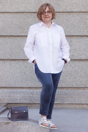 Portrait of mature plus size woman in business style walking around the city and smiling. Life of women after 50-60 yearsの写真素材