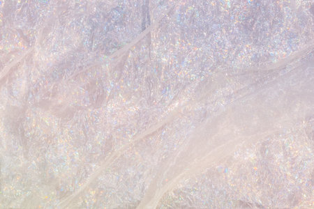 Shiny mother-of-pearl iridescent rainbow silk with glitter. Abstract for design background.の写真素材