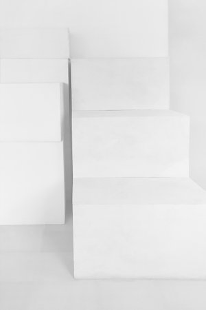 White paper abstract background made of white rectangles in the form of steps or shelves. White model for your design.の写真素材