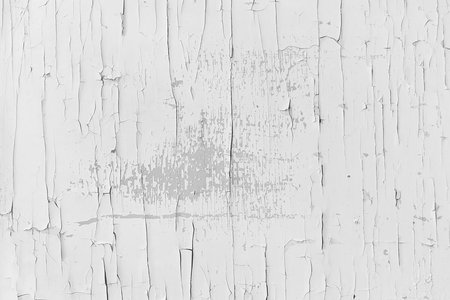 Textured wooden surface covered with white, old, peeling paint and cracks. Cracked paint, vintage background.の写真素材