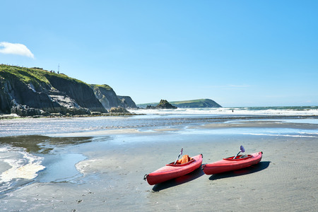 Canoes on Newport Sands, Newport Bay, Pembrokeshire, Dyfed, Wales, UKの写真素材