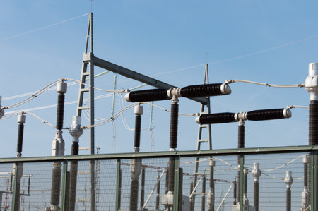 High voltage insulators on the roof of a power plant. High-voltage power lines.