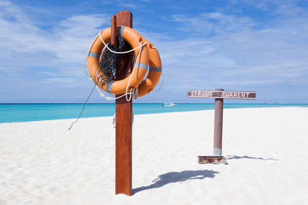 Alert sign on a white beach in Maldive Islandsの写真素材
