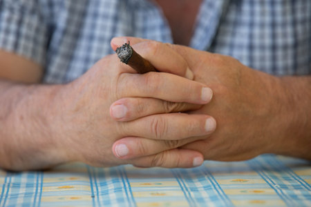 Hands of a man holding a cigarの写真素材