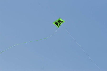 Kite flying in the blue skyの写真素材