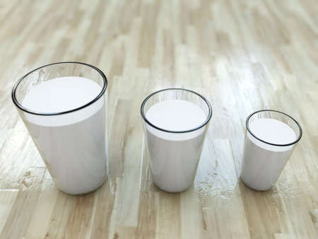 milk glasses on wooden floorの写真素材