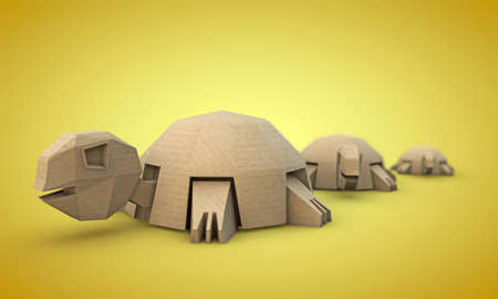 tortoises origami made with cardboard paper isolated on yellow backgroundの写真素材